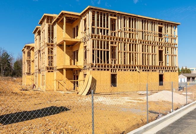 a close-up of temporary chain link fences enclosing a job site, signaling progress in the project's development in Newington